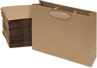 Medium brown paper bags with ribbon handles, made from 120 GSM kraft paper by Prime Line Packaging, stacked next to a single opened bag.