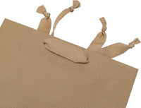 Medium brown paper bag with ribbon handles, made from recyclable brown kraft paper by Prime Line Packaging.